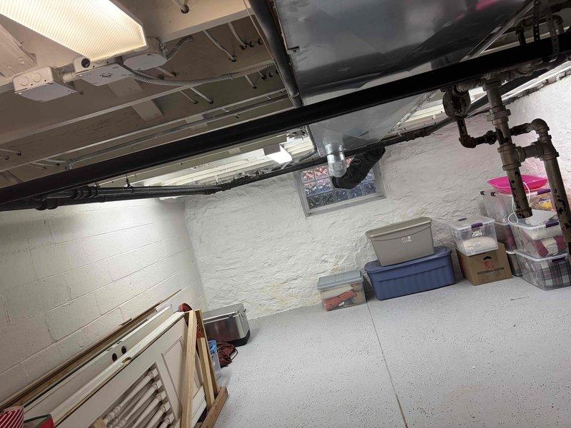 Performed a seasonal heating tune-up on a Weil-McLain boiler serving the hydronic radiator system, including inspection of the boiler, flue venting, and supply/return piping and fittings. Noted surface rust and corrosion on the threaded iron pipe joints and fittings, which should be monitored for leaks. Reviewed radiator operation with the homeowner, including how to turn the radiator valves on and off, to ensure proper heat control throughout multiple rooms.