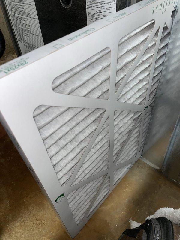 Performed a heating tune-up on a gas furnace, inspecting the inducer motor, pressure switch and tubing, gas valve, burner assembly, flue connection, and wiring harnesses. Noted light discoloration and rust staining around the inducer motor housing for monitoring. Inspected the 20x25x1 pleated return air filter, which showed dust loading, and verified the system was operating properly at completion.