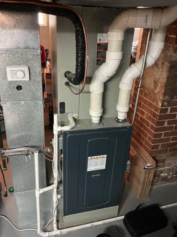 Performed a seasonal tune-up and inspection on a 3-year-old gas furnace, verifying proper thermostat operation and setpoint response, inspecting the burner compartment and heat exchanger, and checking the condensate drain and PVC intake/exhaust venting for secure connections and proper routing. System was found in good working order with no visible rust, leaks, or damage, and operating normally at completion.