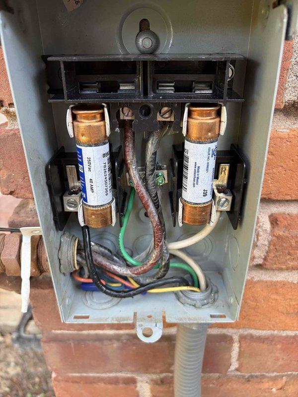 Replaced the 60-amp fuses in the outdoor electrical disconnect with two 40-amp cartridge fuses to properly match the equipment's circuit protection requirements. Verified secure connections at the line and load terminals, and removed the old components from the site.