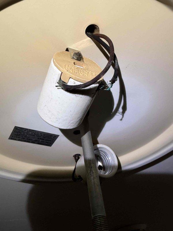 Responded to a blown fuse with partial power loss and inspected the affected circuit. A ceiling light fixture was found with deteriorated, brittle wire insulation and corrosion at the lamp socket, along with a tilted, loosely supported socket assembly, indicating a fault likely responsible for the overcurrent condition. The failed fixture was removed, conductors at the ceiling box were inspected and terminated with wire nuts, and the circuit was made safe pending replacement of the fixture and restoration of the fuse.