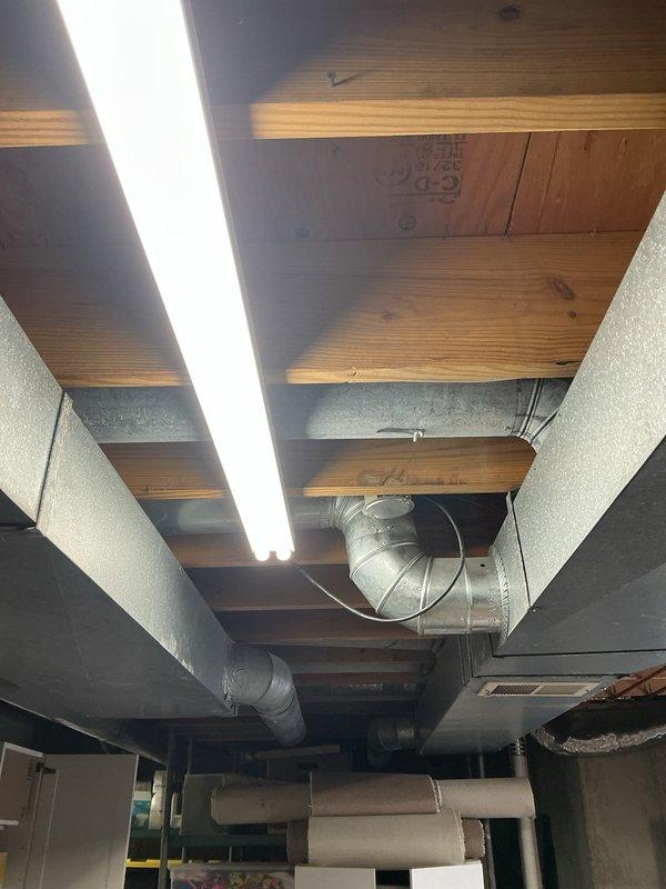 Replaced existing basement light fixtures with new linear LED fixtures mounted to the exposed floor joists, securing them in place and reconnecting to the existing branch circuit wiring. Verified proper operation and illumination of all installed fixtures, and tidied loose cabling along the joists to ensure a clean, code-compliant installation.