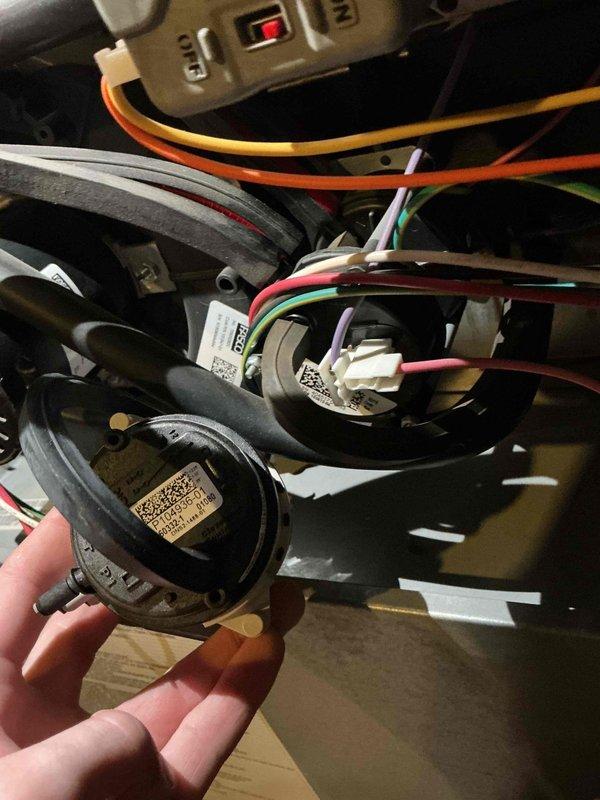 Replaced the furnace pressure switches, installing new OEM switches (P114936-01) with the hose connections and wire harness reconnected to the proper terminals. Removed the old switches and disposed of them, then verified secure hose attachment, proper wiring connections, and no visible damage within the cabinet.