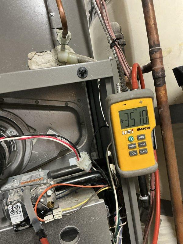 Replaced the failed draft inducer motor on the gas furnace and reconnected the wiring harness, pressure switch tubing, and flue connection. Verified proper inducer operation and pressure switch function with a digital manometer, and confirmed the furnace returned to normal heating operation. Removed the old motor from the site.
