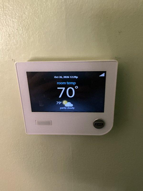 Performed a tune-up on one gas furnace, including removal of the front access panel and visual inspection of the burner compartment, flue pipe, wiring harness, and electrical components. Verified thermostat operation and noted moisture on the flue pipe and cabinet exterior along with dampness on the surrounding floor, indicating possible condensation or a leak that should be evaluated further.