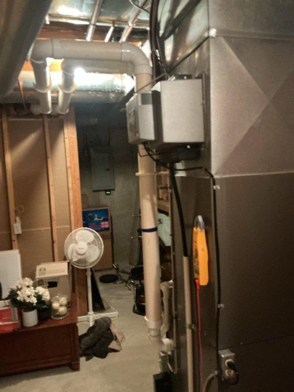 Responded to callback for reported water leakage at Lennox G61MPV gas furnace. Removed lower access panel and inspected the condensate drain system, inducer assembly, and associated PVC drain piping and fittings. Photos document the furnace interior and condensate piping; no definitive leak source or repair is identified in the available documentation, so the findings and corrective action should be confirmed by the technician before this record is finalized.