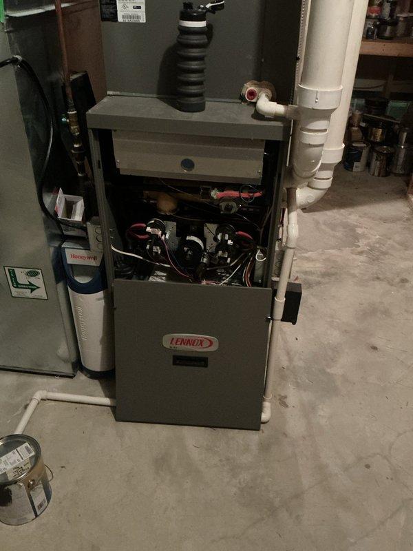 Responded to callback for reported water leakage at Lennox G61MPV gas furnace. Removed lower access panel and inspected the condensate drain system, inducer assembly, and associated PVC drain piping and fittings. Photos document the furnace interior and condensate piping; no definitive leak source or repair is identified in the available documentation, so the findings and corrective action should be confirmed by the technician before this record is finalized.