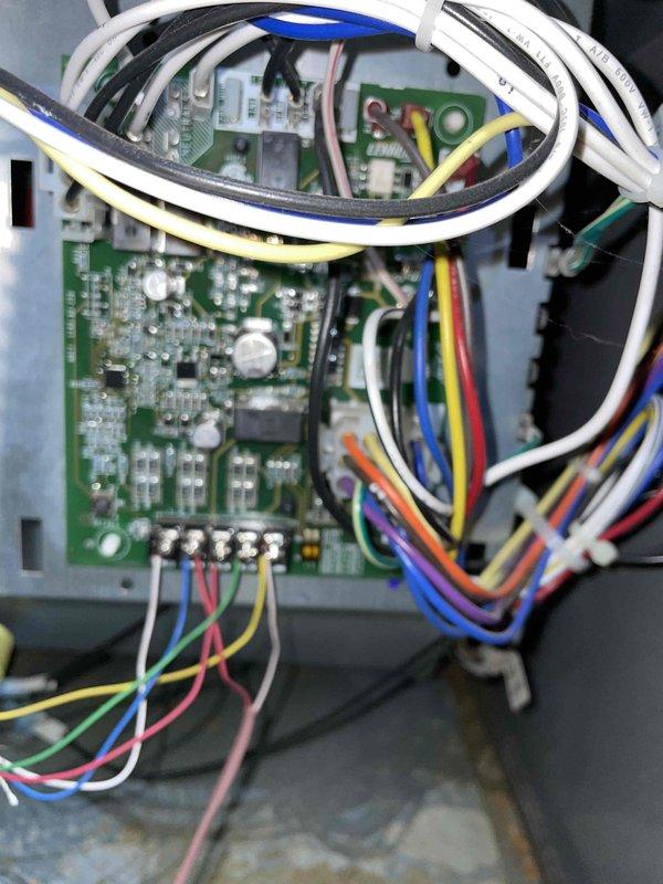 Responded to a no-heat call for a burning odor from a Lennox furnace installed in a crawlspace. Inspected the furnace control cabinet and integrated control board, including terminal block connections and low-voltage wiring harness, and found no evidence of burn marks, corrosion, overheating, or damaged conductors. System was found shut off by the homeowner; the cause of the odor was not conclusively identified from visual inspection of the control board and wiring.