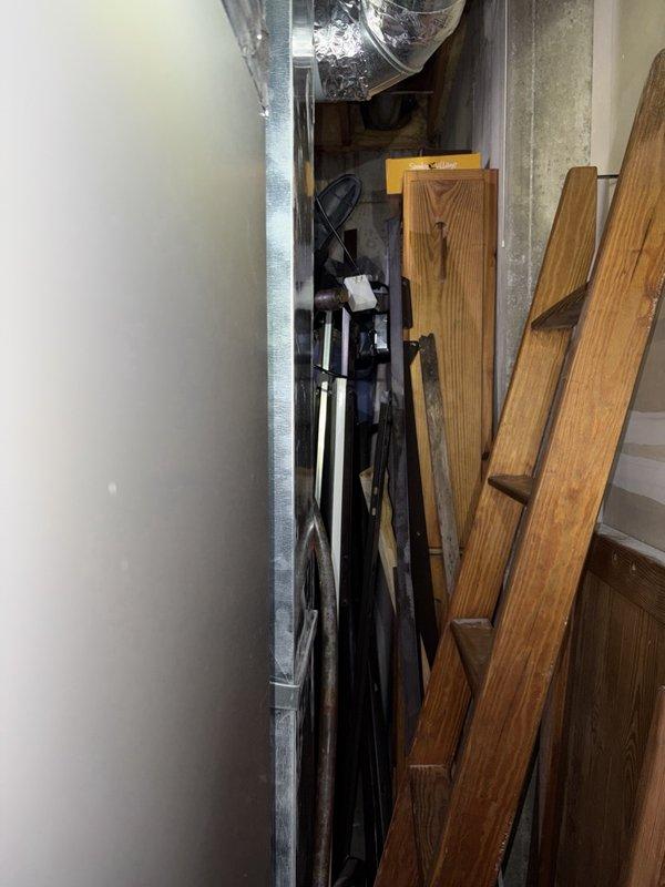 Inspected the A/C system for reported condensate drain concerns and found the condensate drain line discolored. Evaluated the air handler cabinet and observed significant rust staining and debris accumulation along the cabinet floor and seams, consistent with prior moisture exposure from drain line issues. Recommended replacing the condensate drain line and addressing the source of moisture to prevent further corrosion and water damage.