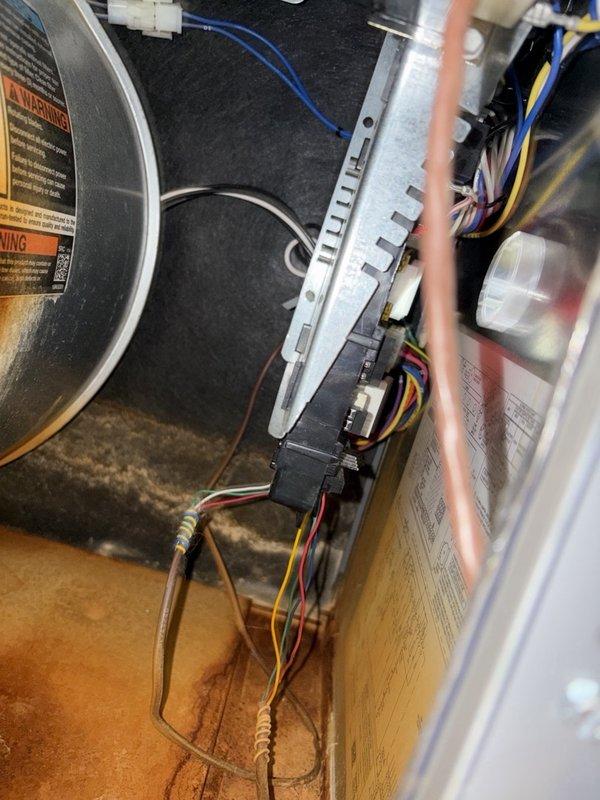 Inspected the A/C system for reported condensate drain concerns and found the condensate drain line discolored. Evaluated the air handler cabinet and observed significant rust staining and debris accumulation along the cabinet floor and seams, consistent with prior moisture exposure from drain line issues. Recommended replacing the condensate drain line and addressing the source of moisture to prevent further corrosion and water damage.