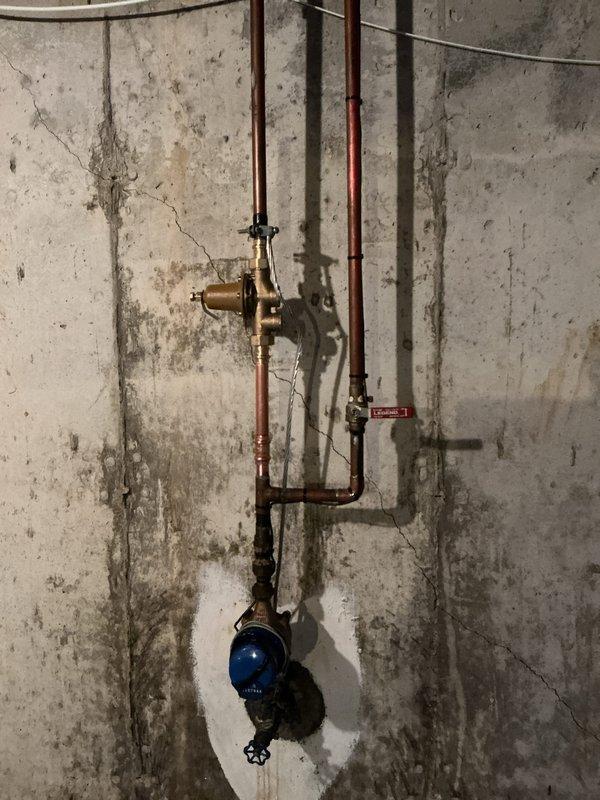 Installed a new 40-gallon tall gas tanked water heater, connecting the water supply and gas lines and venting the unit with 4" flue piping. Verified the installation is secure, leak-free, and operating properly, with the existing pressure-reducing valve and shutoff valves in the basement utility space left in place.