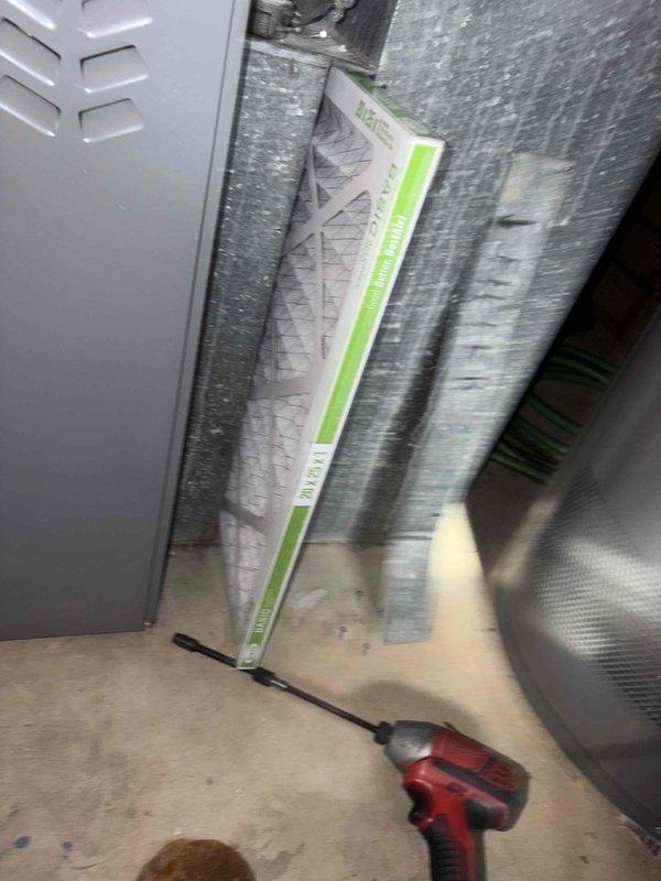 Performed a seasonal heating tune-up on a 15-year-old furnace, inspecting the cabinet, ductwork, and associated components and confirming the system was operating properly. Replaced the 20x25x1 pleated air filter and inspected the whole-house humidifier, noting heavy mineral scale buildup on the water panel that will need replacement or cleaning for proper humidification. System left in working condition.