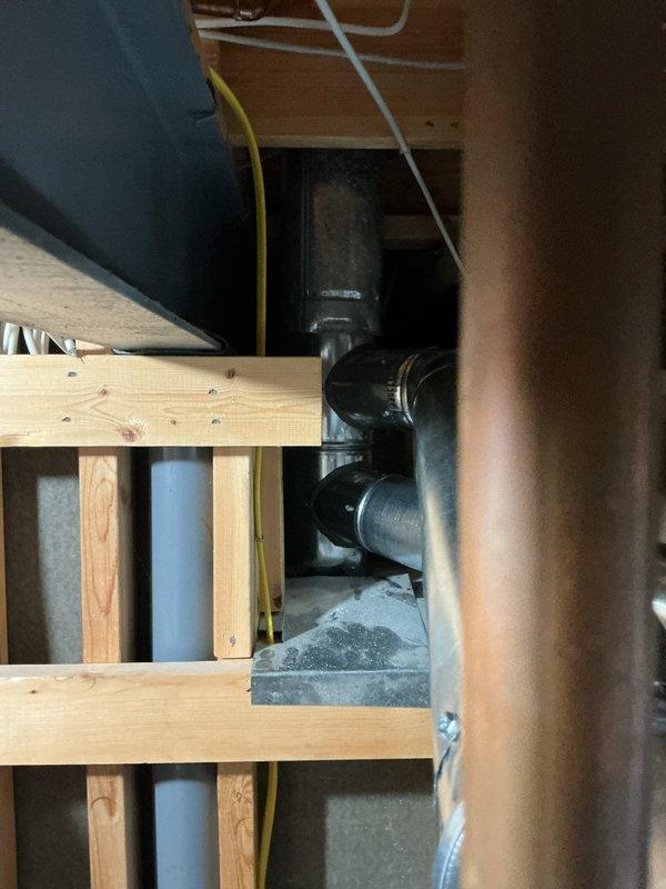 Repaired the flue venting by replacing the 5"x4"x4" flue tee, a 10' length of 4" flue pipe, and a 5"x4" elbow, then secured the connections with hose clamps. Removed the old components and verified the flue run was properly joined and supported for safe exhaust.