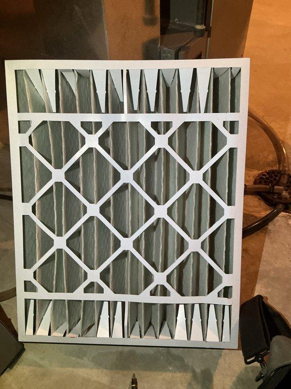 Performed a heating tune-up on the basement-installed furnace, including inspection of the unit and its condensate drain components. Removed the existing pleated air filter, which showed minor discoloration along the pleat edges, and replaced it to restore proper airflow and system efficiency.