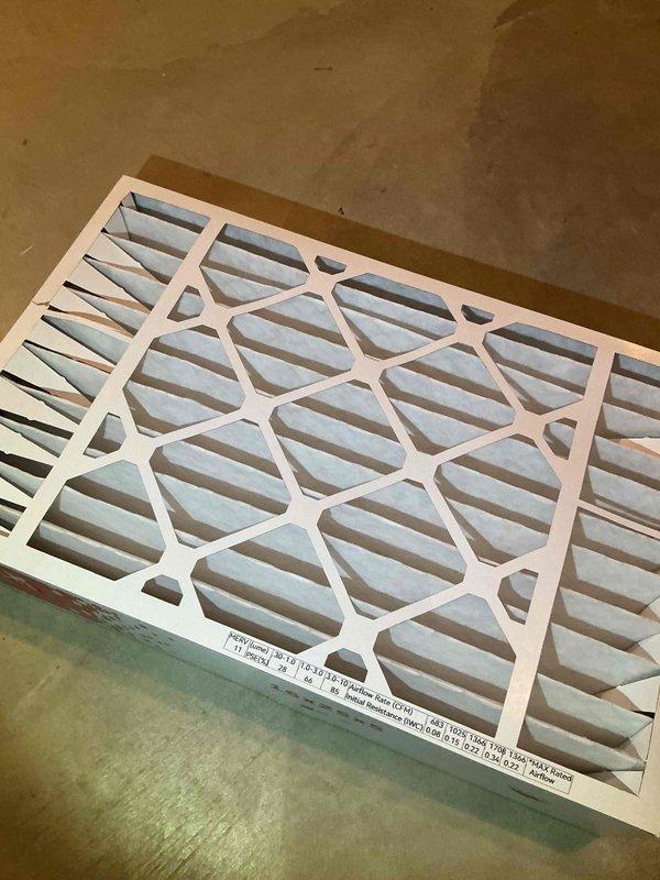 Performed a heating tune-up on the basement-installed furnace, including inspection of the unit and its condensate drain components. Removed the existing pleated air filter, which showed minor discoloration along the pleat edges, and replaced it to restore proper airflow and system efficiency.