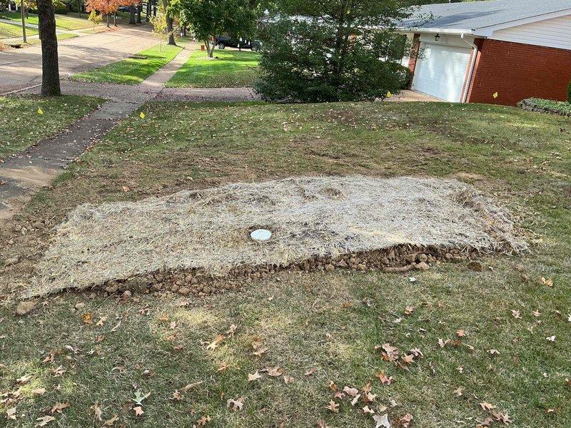 Completed sewer lateral repair under approved municipal plumbing permit PLUM-26-0688, including excavation, exposing the lateral, and installing new pipe with a capped cleanout/access riser. Trench was backfilled and compacted, with gravel base restored and the disturbed area covered with straw mulch for erosion control. Municipal inspection has been scheduled for the completed work.