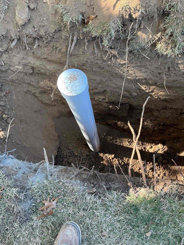 Completed sewer lateral repair under approved municipal plumbing permit PLUM-26-0688, including excavation, exposing the lateral, and installing new pipe with a capped cleanout/access riser. Trench was backfilled and compacted, with gravel base restored and the disturbed area covered with straw mulch for erosion control. Municipal inspection has been scheduled for the completed work.