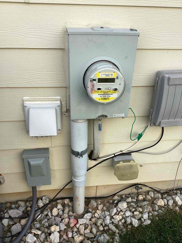 Investigated recurring nuisance tripping on multiple 15 AMP AFCI/GFCI-type breakers (yellow test button) at the basement main panel, inspecting the service entrance, meter base, and panel interior for loose terminations, overheating, or damaged conductors. Tested affected circuits, verified breaker operation, and restored normal service with no visible signs of damage, corrosion, or overload at the panel or meter enclosure.