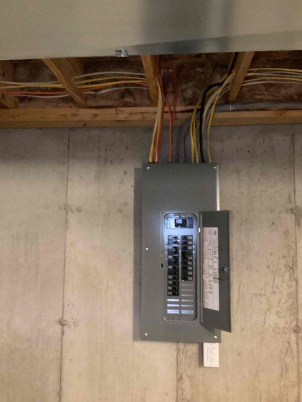 Investigated recurring nuisance tripping on multiple 15 AMP AFCI/GFCI-type breakers (yellow test button) at the basement main panel, inspecting the service entrance, meter base, and panel interior for loose terminations, overheating, or damaged conductors. Tested affected circuits, verified breaker operation, and restored normal service with no visible signs of damage, corrosion, or overload at the panel or meter enclosure.