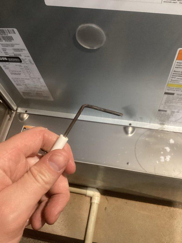Performed a heating tune-up on a 10-year-old Bryant gas furnace, inspecting the cabinet, flue piping, gas connections, and PVC condensate drain for proper installation, leaks, and corrosion, with none found. Removed and inspected the flame sensor, which showed carbon buildup on the rod, and cleaned it to restore reliable flame sensing. The system was confirmed to be operating properly at the time of service.
