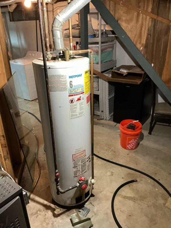 Installed a new 40-gallon tall gas tank-type water heater, connecting the cold and hot water lines, gas supply with control valve, and flue venting to the existing overhead ductwork. Verified proper connections and system operation, with the unit set up for delivery and the work meeting jurisdictional requirements.