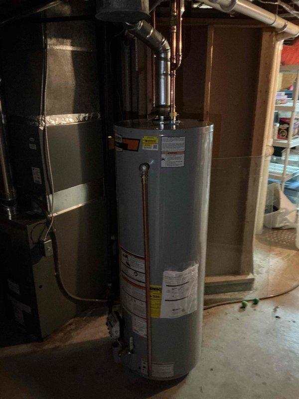 Installed a new 40-gallon tall gas tank-type water heater, connecting the cold and hot water lines, gas supply with control valve, and flue venting to the existing overhead ductwork. Verified proper connections and system operation, with the unit set up for delivery and the work meeting jurisdictional requirements.