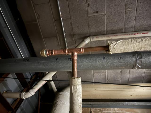 A new expansion tank was installed to manage water pressure fluctuations, ensuring the system's longevity and efficiency. This involved precise placement and securing the tank with a sturdy strap to maintain stability. Additionally, an antisiphon vacuum breaker was installed on the water heater. This critical component prevents backflow, safeguarding the water supply from contamination. The installation process required careful attention to detail, ensuring all connections were secure and functioning correctly. The system is now better equipped to handle pressure changes and maintain water quality.