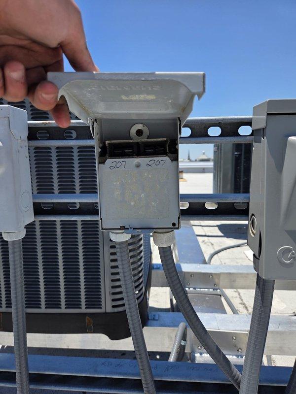 Charleston, SC - Performed leak test on rooftop HVAC unit using refrigerant gauge manifold and electronic leak detector, documenting pressure readings of 207 PSI and 227 PSI during diagnostic evaluation. Inspected condensing unit components and identified areas requiring repair, capturing photographic documentation of equipment condition for estimate preparation.