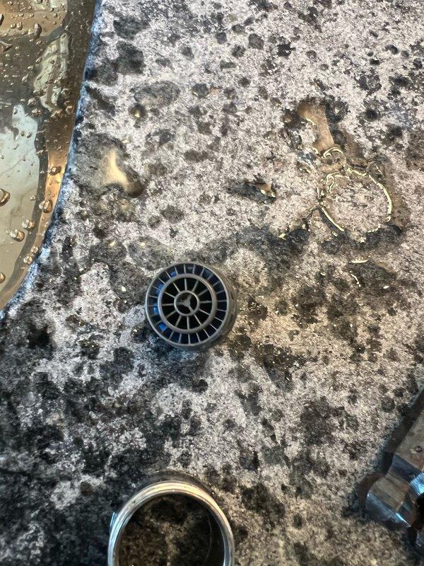 Responded to multiple plumbing concerns including a non-functional exterior water faucet, sewage odor emanating from the downstairs bathroom in the garage/mechanical room area, and a temperature control issue in the master bathroom tub where only hot water was available. Upon inspection, diagnosed the exterior faucet for potential valve failure or freeze damage, investigated the sewer gas smell by examining drain traps and vent system components in the affected bathroom area, and assessed the tub's mixing valve for malfunction preventing cold water flow. Documented existing conditions with photographic evidence showing drain components and surrounding fixtures for reference and potential follow-up repairs.