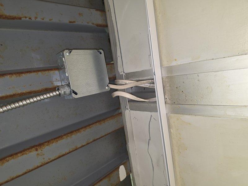 Removed and replaced accessible existing Romex wiring serving the break room lighting with MC cable to meet current code requirements. Completed wiring and final connections for six remaining light fixtures, then tested all lighting circuits to verify proper operation upon completion.