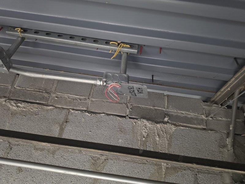 Completed electrical junction box inspection and organization in commercial space. Secured wire connections using appropriate wire nuts, verified proper conductor splicing of black, white, and green wires within metallic junction box mounted on metal stud framing. Ensured all flexible metallic conduits entering box were properly secured and connections met code requirements. All junction boxes serviced and left in compliant condition with proper covers installed.