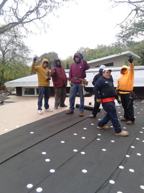 Happy crew taking a 5 minute break from flat roof installation. Happy crew taking a 5 minute break from flat roof installation.