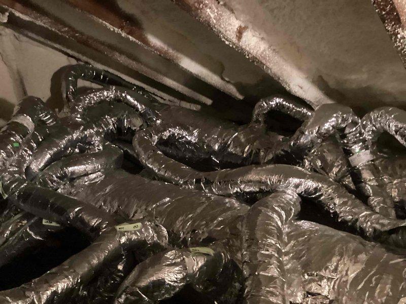 Completed comprehensive inspection of HVAC system in crawlspace/attic area, focusing on the condition of flexible ductwork and air handler unit. Verified integrity of black insulation covering on all distribution pipes, checked connections at branch points, and confirmed proper installation of the central air handler with associated wiring. Documentation photos taken of the complete system for service records.