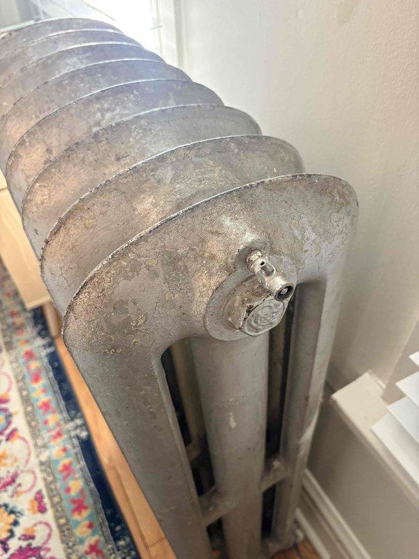 Responded to service call regarding non-functioning radiators on multiple floors. Inspected both vintage cast iron radiator and wall-mounted panel radiator, identifying circulation issues in the hydronic heating system. Successfully restored heat flow by bleeding air from radiators and adjusting system pressure to manufacturer specifications.