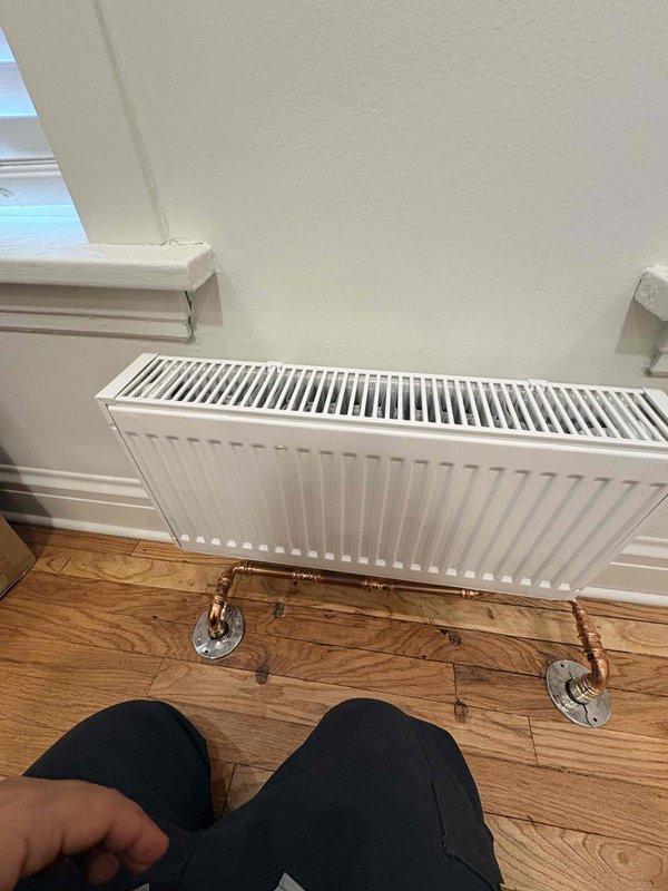 Responded to service call regarding non-functioning radiators on multiple floors. Inspected both vintage cast iron radiator and wall-mounted panel radiator, identifying circulation issues in the hydronic heating system. Successfully restored heat flow by bleeding air from radiators and adjusting system pressure to manufacturer specifications.