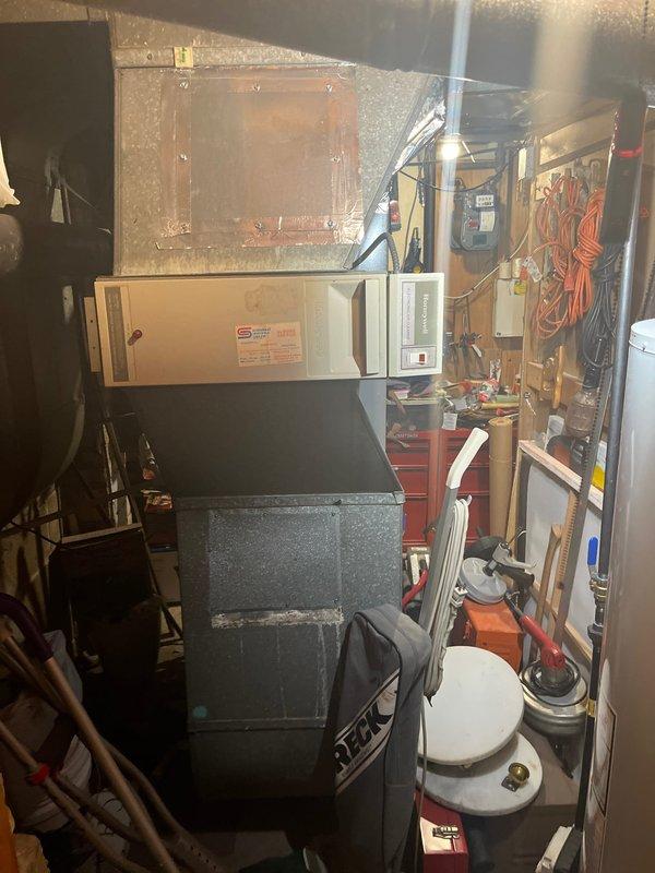 Performed diagnostic assessment on 20-year-old furnace system that was blowing cool air instead of heat. Inspection of the Goodman unit revealed significant wear and deterioration of critical components, with improper exhaust venting observed. Recommended complete system replacement due to age, efficiency concerns, and repair costs exceeding replacement value.