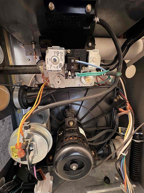 Responded to emergency no-heat call for commercial furnace that was shutting down shortly after reset attempts. Diagnosed faulty gas valve with improper electrical signals, as evidenced by inspection of control valve with ON/OFF markings and associated blue/green wiring. Replaced gas valve, verified proper ignition sequence, and restored heating system to normal operation, bringing the temperature up from 56° to the programmed 73° setpoint on the Honeywell thermostat.