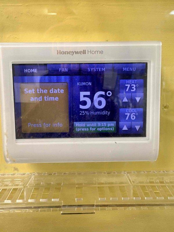 Responded to emergency no-heat call for commercial furnace that was shutting down shortly after reset attempts. Diagnosed faulty gas valve with improper electrical signals, as evidenced by inspection of control valve with ON/OFF markings and associated blue/green wiring. Replaced gas valve, verified proper ignition sequence, and restored heating system to normal operation, bringing the temperature up from 56° to the programmed 73° setpoint on the Honeywell thermostat.
