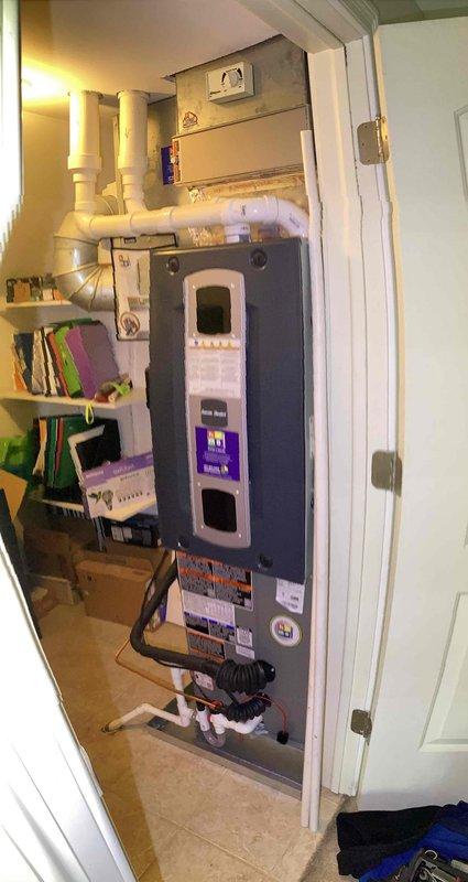 Conducted inspection of HVAC system with water damage concerns. Examined interior components including circuit board (displaying "055") and associated wiring connections. Evaluated condensate drain system and assessed coil pan area for potential silicone application as preventative measure against future water leakage.