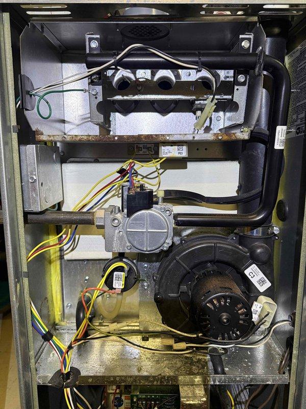 Performed diagnostic testing on 8-year-old furnace experiencing insufficient heating performance. Inspection revealed signs of corrosion on internal components. Conducted electrical measurements using clamp meter, confirming proper voltage readings (111.1V/42.5V) to system components. Recommended comprehensive cleaning and check-up service to improve heating efficiency.