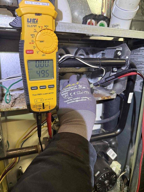 Performed diagnostic testing on 8-year-old furnace experiencing insufficient heating performance. Inspection revealed signs of corrosion on internal components. Conducted electrical measurements using clamp meter, confirming proper voltage readings (111.1V/42.5V) to system components. Recommended comprehensive cleaning and check-up service to improve heating efficiency.