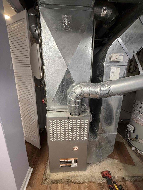 Successfully replaced Air Scrubber UV bulb in residential HVAC system located in utility closet. System includes furnace unit with connected ductwork and air handler. Documented installation with photos for service records.