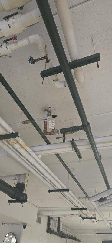 Responded to a water leak issue in a multi-unit building, specifically addressing a leak from an upper unit affecting the unit below. Accessed the building's unique hydronic heating system, which features supply lines through the garage and return lines through the 9th floor ceiling, to repair a defective fitting above the shut-off valve leading to in-floor radiant heat. Completed necessary system drainage, fitting repair, and system refill with air purging to restore proper operation.