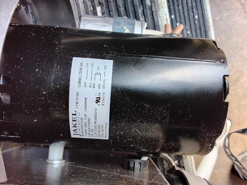 Returned to replace HS2 Power Vent assembly under warranty as previously diagnosed. Successfully removed defective Jakel motor unit showing dust accumulation and installed new power vent component after reconnecting the electrical wiring harness (yellow, green, black, and red wires) to the junction box.