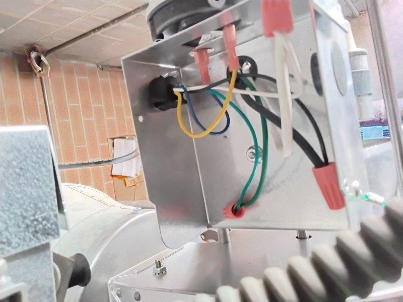 Returned to replace HS2 Power Vent assembly under warranty as previously diagnosed. Successfully removed defective Jakel motor unit showing dust accumulation and installed new power vent component after reconnecting the electrical wiring harness (yellow, green, black, and red wires) to the junction box.