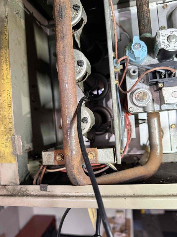 Performed comprehensive tune-up service on customer's HVAC systems, including inspection of one split system and one unit heater as noted from previous records. Observed significant oxidation and wear on copper piping components, particularly in the heating system. Inspected electrical connections, including transformer/relay components and wiring integrity, noting some aging insulation on control wiring. Documented equipment specifications and system condition for maintenance plan development.