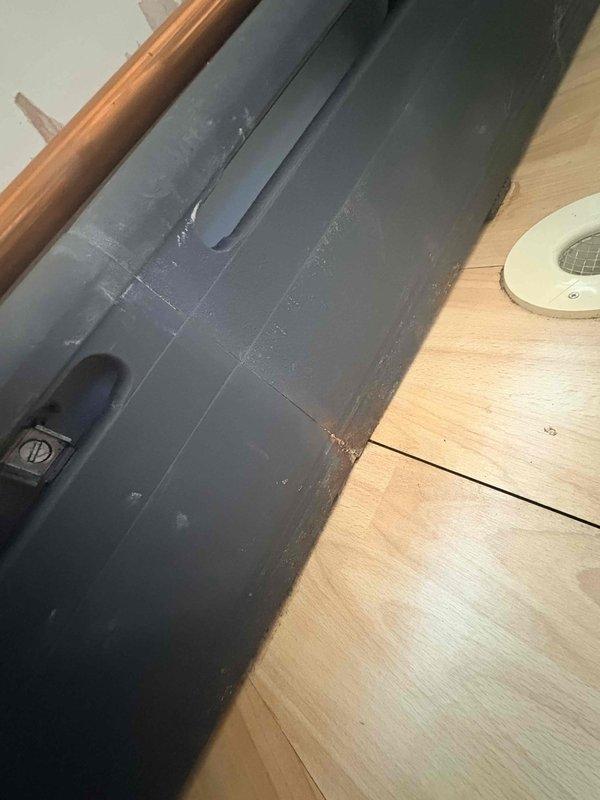 Diagnosed a leaking cast iron baseboard radiator on the second floor, which was installed in sections with a failed connection at the seam. Confirmed isolation valves for the zone, documented the leak location with photos, and recorded equipment information including the Carrier heating system located in the basement mechanical area.