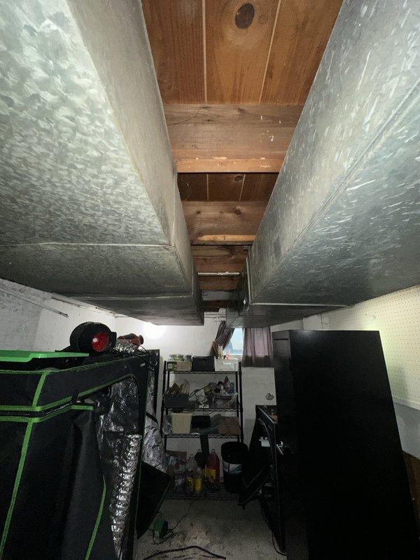 Performed site assessment for relocation of existing furnace and associated ductwork. Evaluated current basement installation, taking measurements of ceiling height (approximately 22 inches clearance) and documenting existing duct configuration. Assessed structural considerations including exposed joists and available space for equipment repositioning.