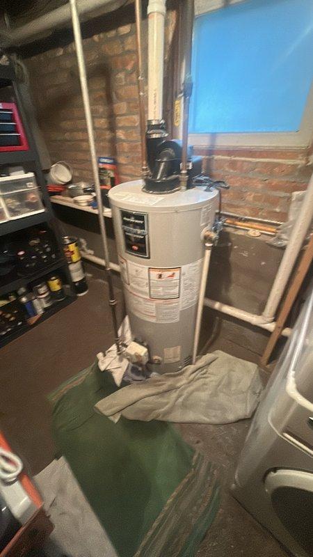 Conducted a detailed estimate for replacement of a 40-gallon PVC-vented water heater in basement utility area. Inspected existing unit showing age-related wear and documented current installation including venting configuration and connection points. Explained permit requirements and applicable customer discount, though clarification was needed regarding initial permit information provided.