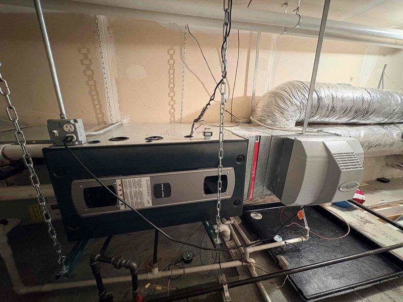 Diagnosed leaking Aprilaire humidifier installed on residential HVAC system that was causing operational issues with the furnace. Documented the installation configuration, including the ceiling-mounted air handler and associated ductwork. Customer had temporarily disabled the humidifier prior to service call.